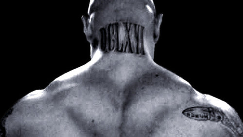 Black-and-white rear view of Jim Wendler showing his neck and traps