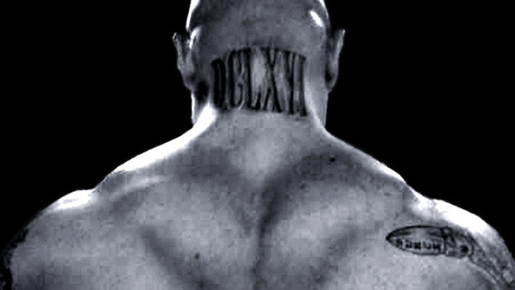 Black-and-white rear view of Jim Wendler showing his neck and traps