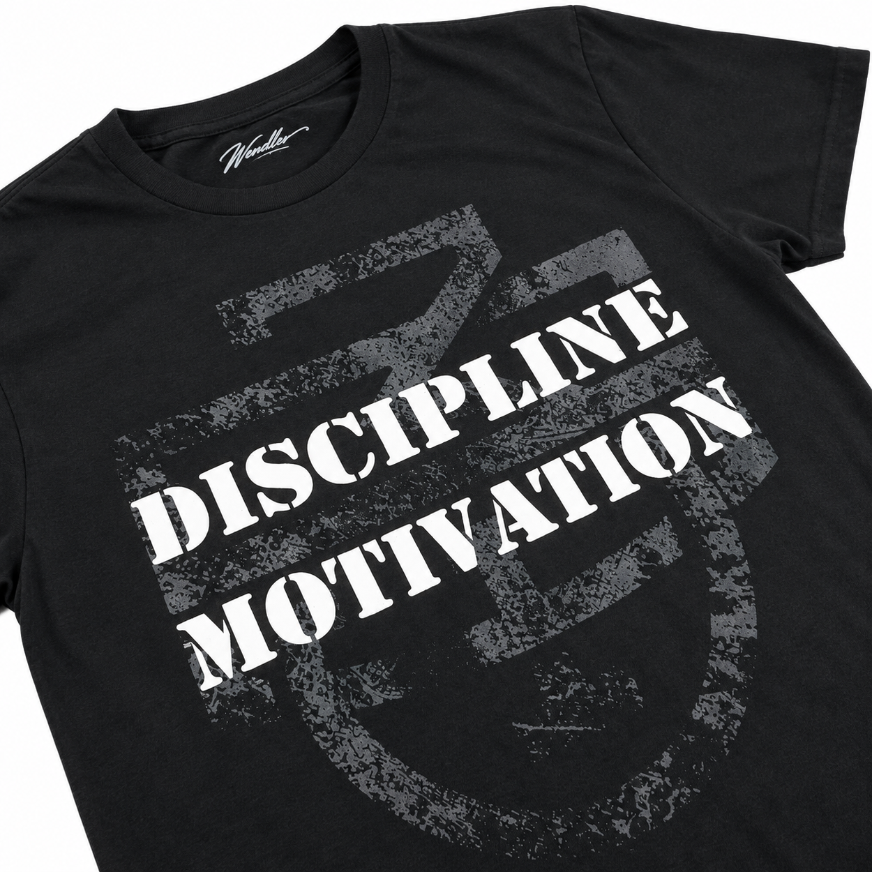 Close-up of distressed Discipline Over Motivation graphic on black D/M Monogram Shirt