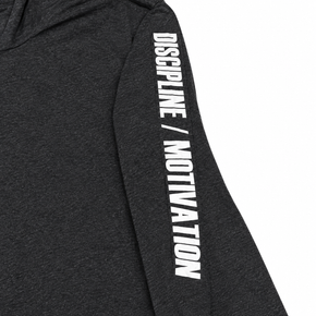 Close-up of white Discipline Over Motivation print on the heathered black shirt sleeve