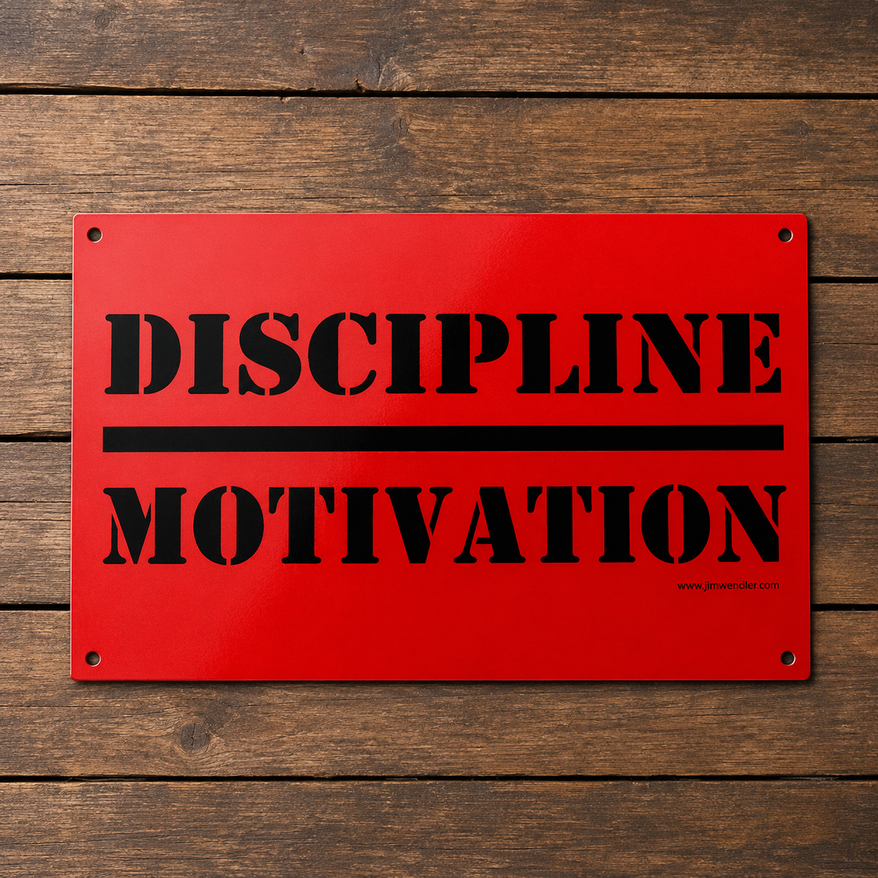Red Discipline Over Motivation aluminum wall sign with black stencil lettering on a wood background.