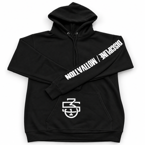 A black pullover hoodie with white graphic text on the sleeve reading 'DISCIPLINE / MOTIVATION' and a white circular logo on the front pocket, shown on a plain white background.