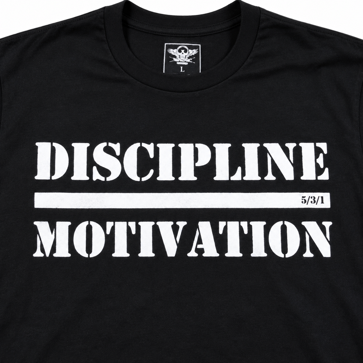 Close-up of the white Discipline Over Motivation print on a black shirt.