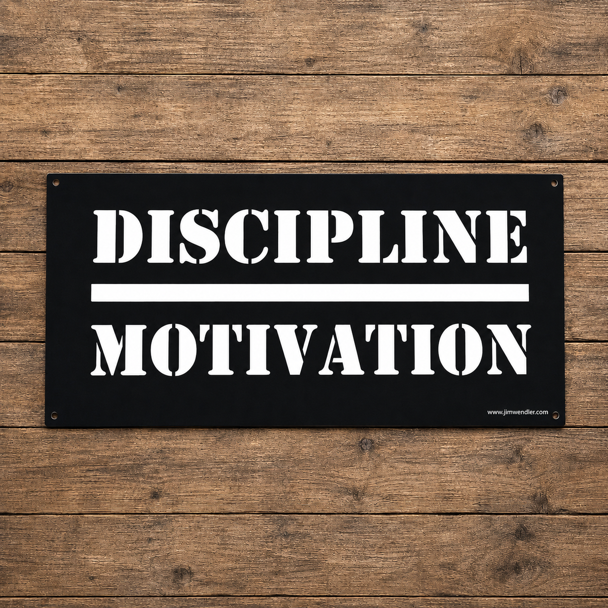 Black Discipline Over Motivation wall sign with white stencil lettering on a wood background.