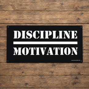 Black Discipline Over Motivation wall sign with white stencil lettering on a wood background.