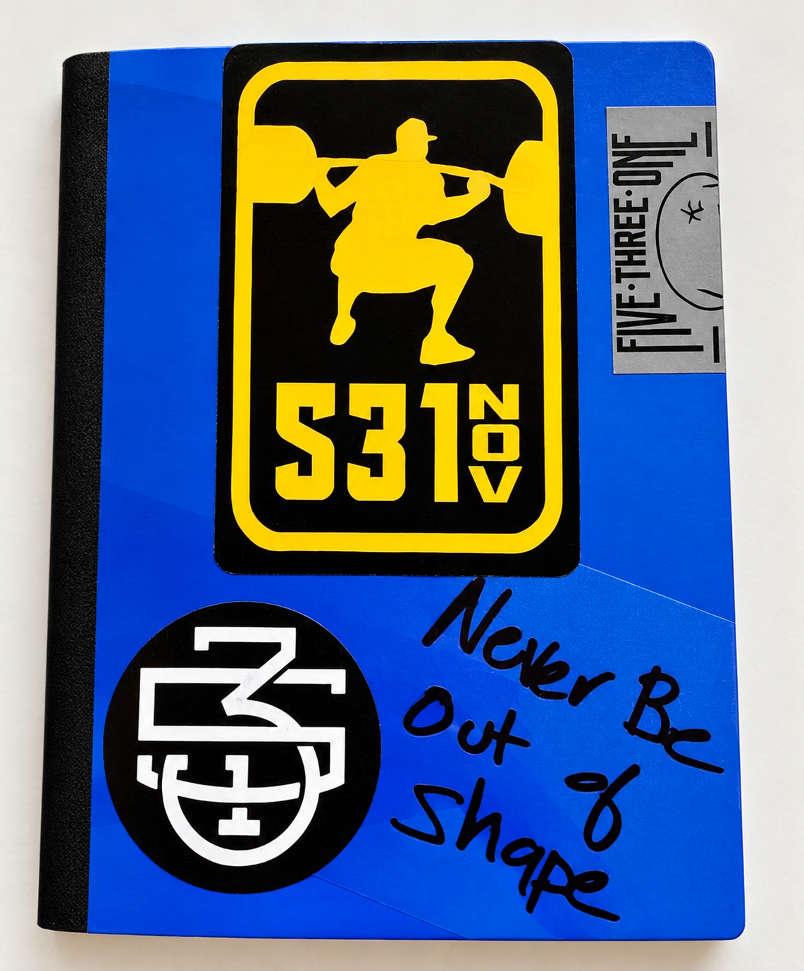 Never Be Out of Shape clear sticker applied to a blue training log, showing the colored surface through its background.